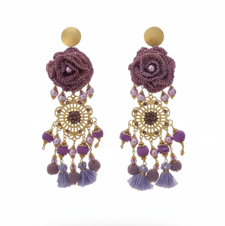 Pair of purple floral earrings with gold and purple accents on a white background