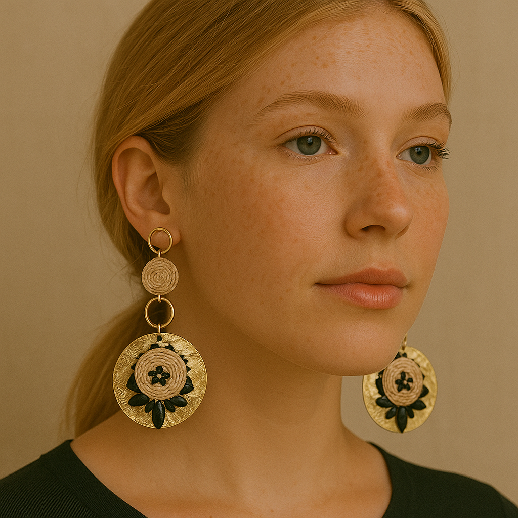 Model wearing gold handcrafted earrings with circular woven floral centerpiece