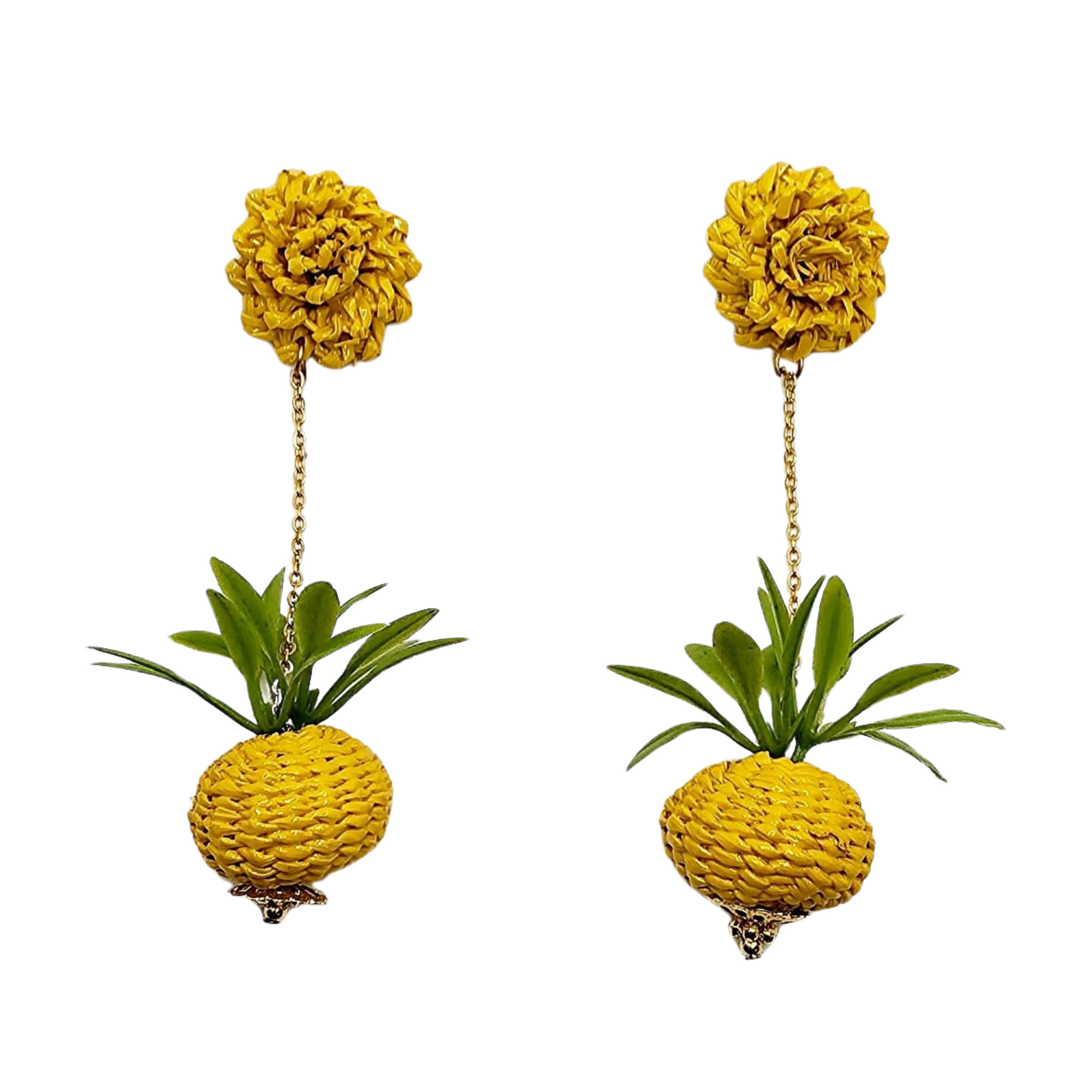 A pair of golden pineapple-shaped earrings with green accents, hanging from chains.
