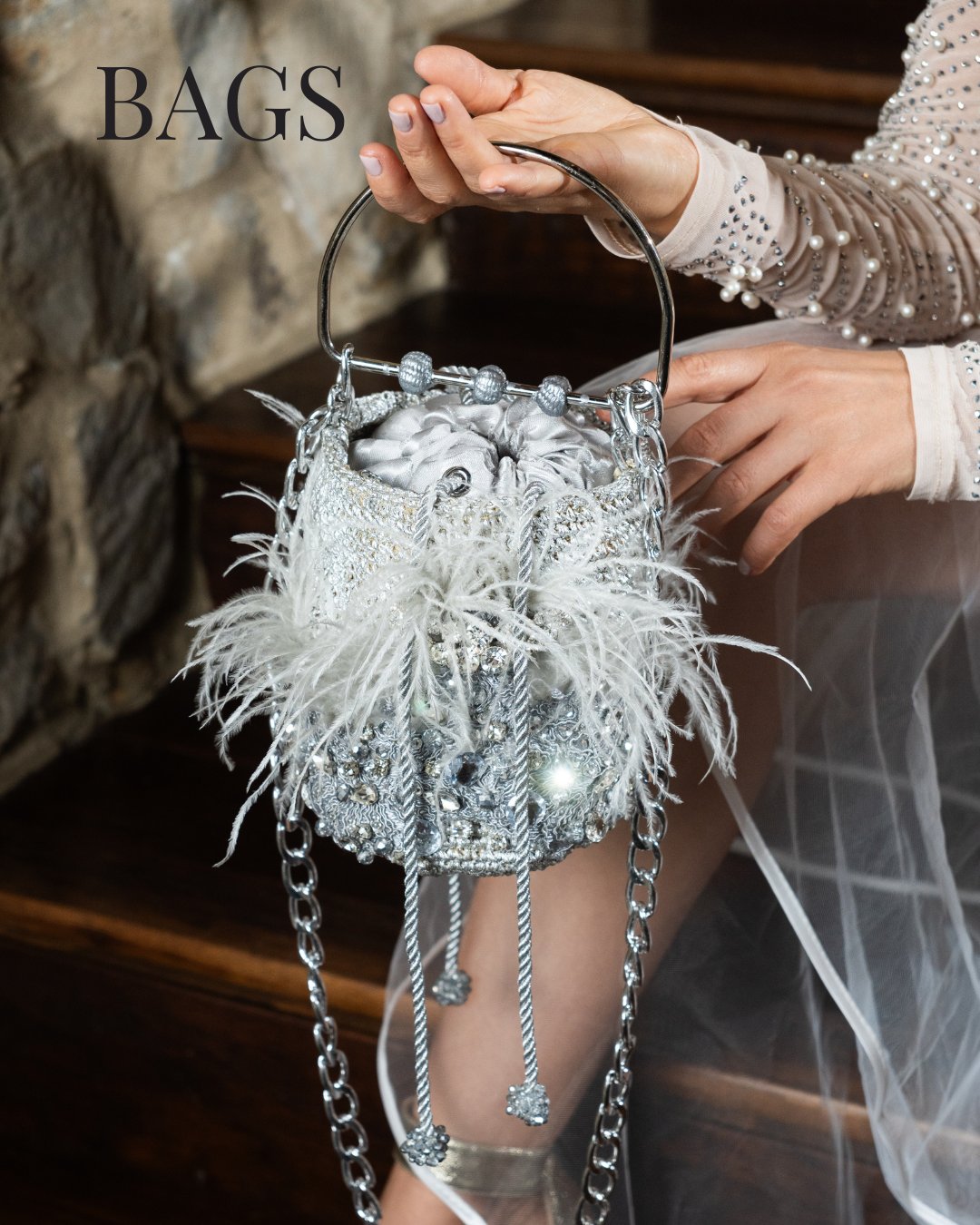 Yama by His Grace silver minaudière bag with white feathers and crystal rhinestones, artisanal handbag from Colombia.