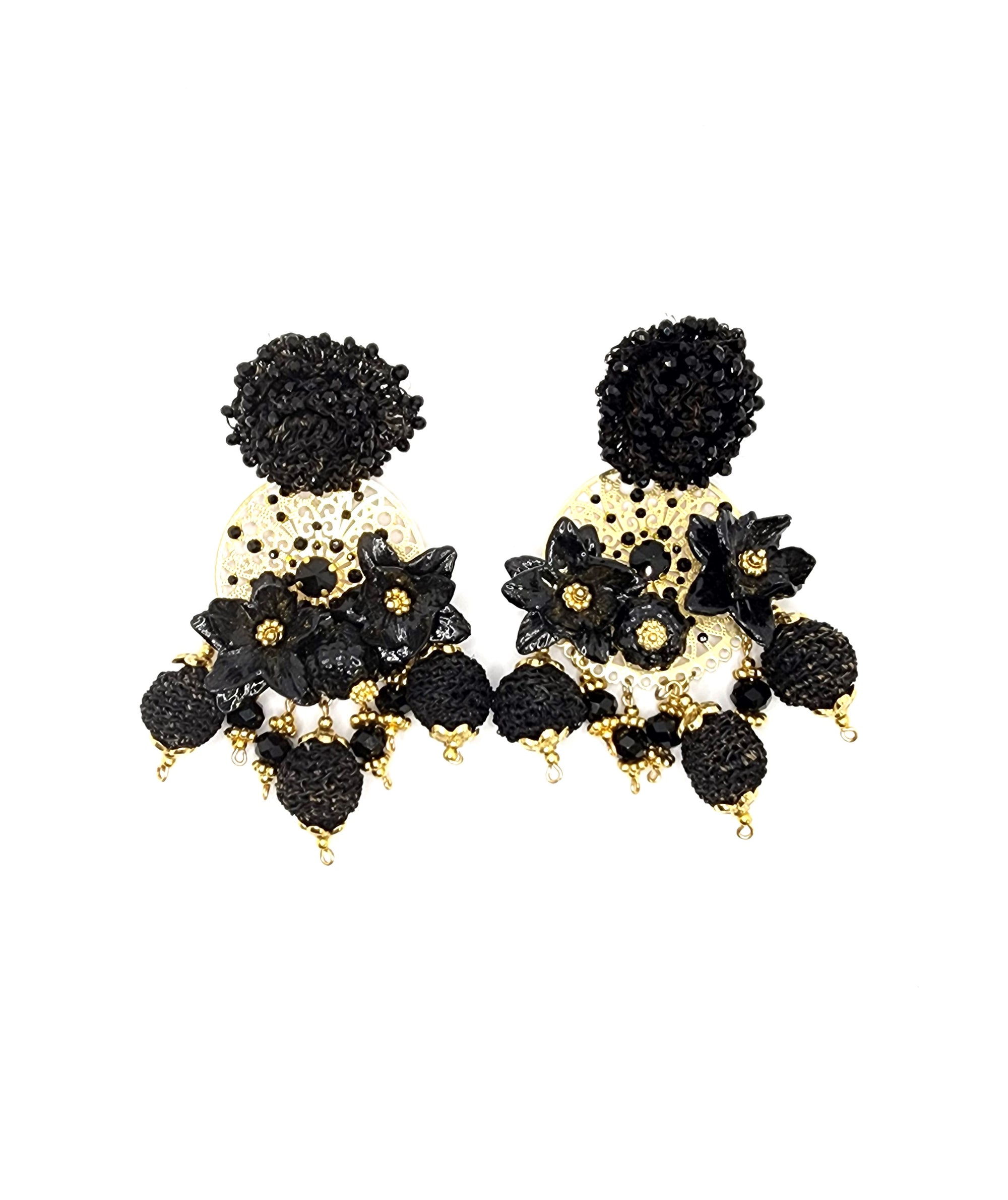 Pair of handcrafted black and gold earrings with floral details and textured dangling beads.