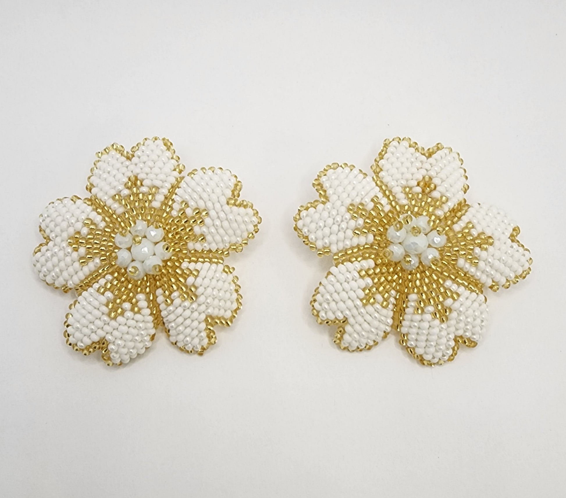 Handcrafted floral earrings with intricate white and gold beadwork, creating a timeless and elegant design