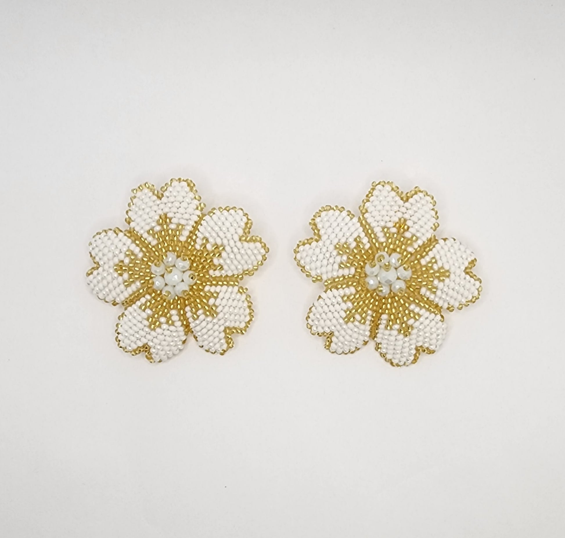 Handcrafted floral earrings with intricate white and gold beadwork, creating a timeless and elegant design