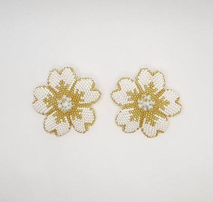 Handcrafted floral earrings with intricate white and gold beadwork, creating a timeless and elegant design