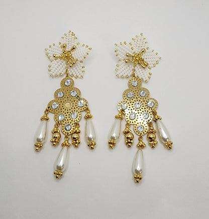 Handcrafted gold chandelier earrings with floral tops, rhinestones, and pearl-like teardrops.