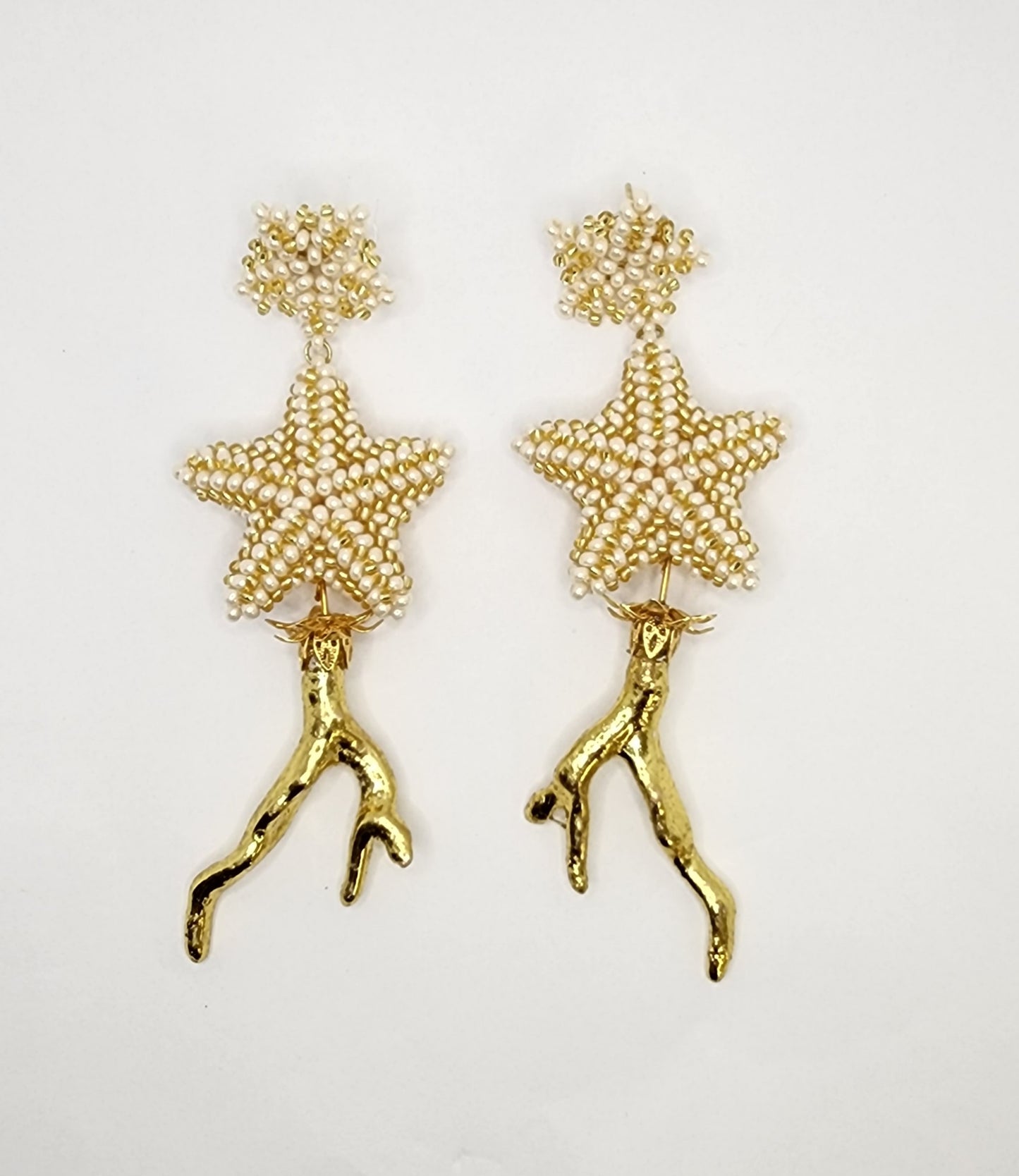 Handcrafted earrings featuring pearl-beaded stars and gold branch-like accents, combining elegance and unique organic design.