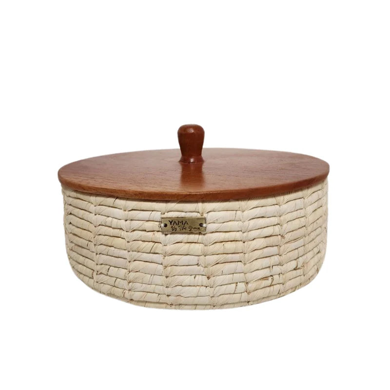 Our artisanal vegetable fiber basket with wooden accents is a stunning blend of natural beauty and timeless craftsmanship. Handcrafted by skilled artisans, each basket features unique wooden details that add warmth and elegance to any space.