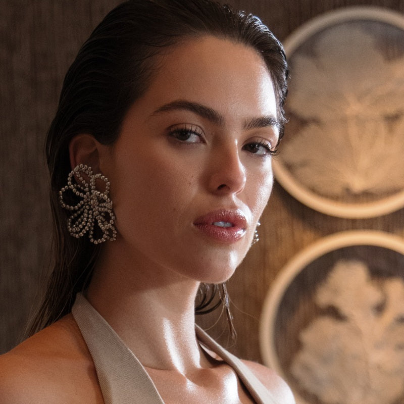 woman wearing a stament earrings