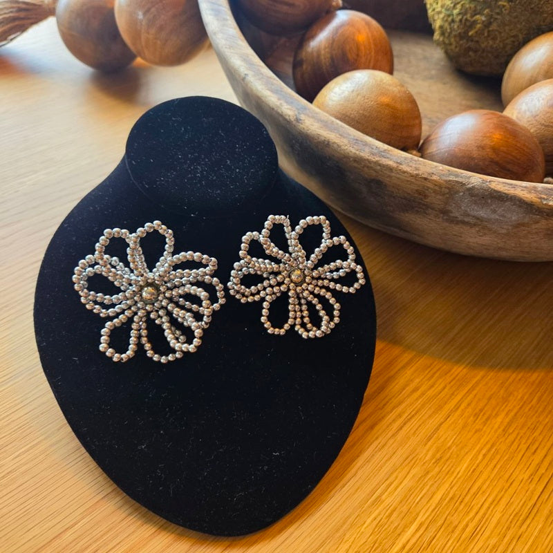  Their design pays homage to the organic beauty of a statement flower, brought to life through a meticulous lattice of impeccably finished beads, ensuring maximum comfort for your most memorable moments