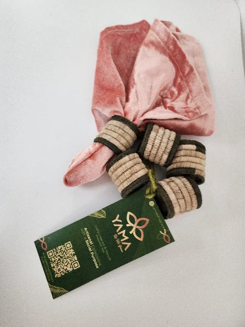Elevate your dining experience with this set of 5 handcrafted artisanal napkin rings. Made from natural fiber, each ring features a dark border with a natural fiber center, adding a sophisticated touch to your table setting. Skillfully crafted by Colombian artisans, these napkin rings offer a perfect blend of rustic charm and elegance, ideal for any occasion.