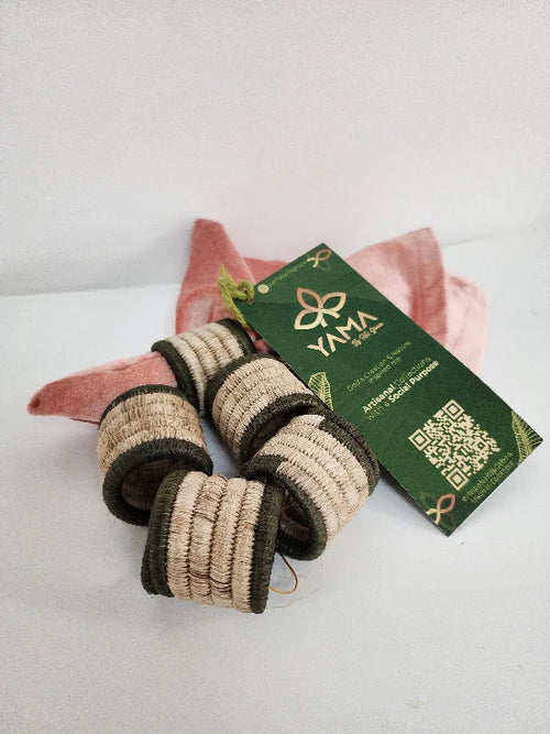 Elevate your dining experience with this set of 5 handcrafted artisanal napkin rings. Made from natural fiber, each ring features a dark border with a natural fiber center, adding a sophisticated touch to your table setting. Skillfully crafted by Colombian artisans, these napkin rings offer a perfect blend of rustic charm and elegance, ideal for any occasion.