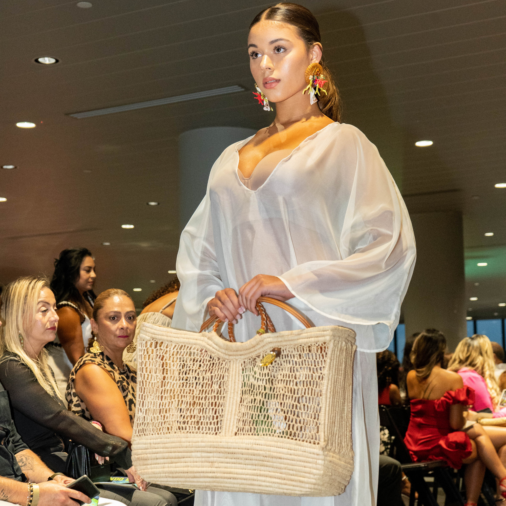 Close-up of fashion model holding Enea Leather Beach Bag during catwalk event