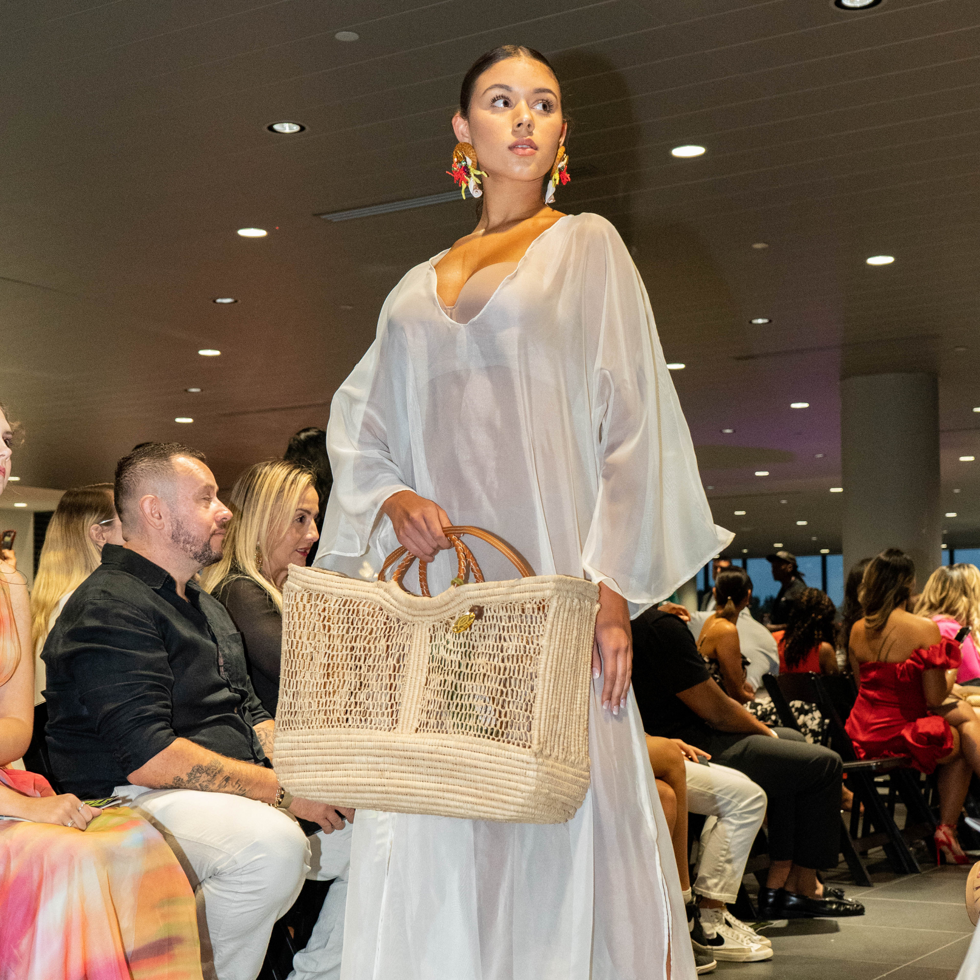 Runway model showcasing Enea Leather Beach Bag during fashion show