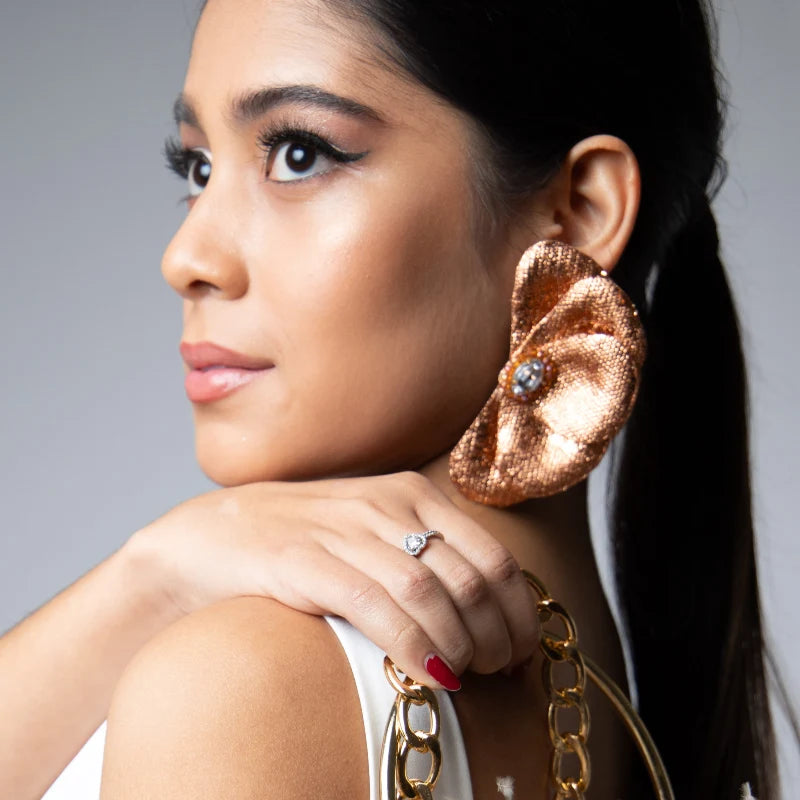 woman wearing a big petal earrings 