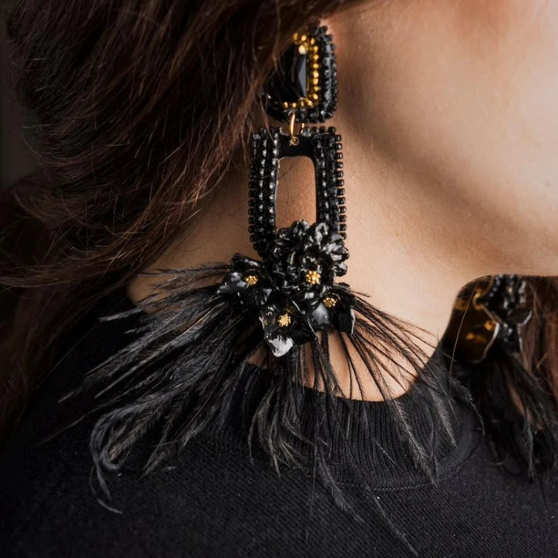 woman wearing statement black earrings