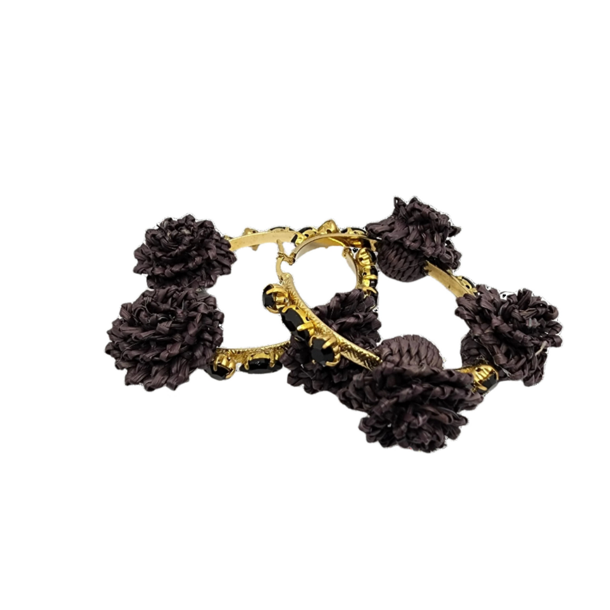 Pair of gold hoop earrings adorned with black raffia flowers and faceted black beads, showcasing handcrafted Colombian design.