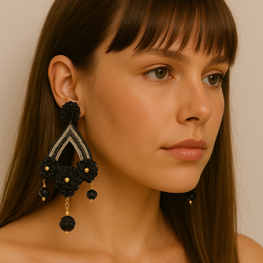 Model wearing Black & Gold Flower Totumo Earrings with black fiber flowers, gold accents, and gemstone details — artisan handcrafted jewelry.