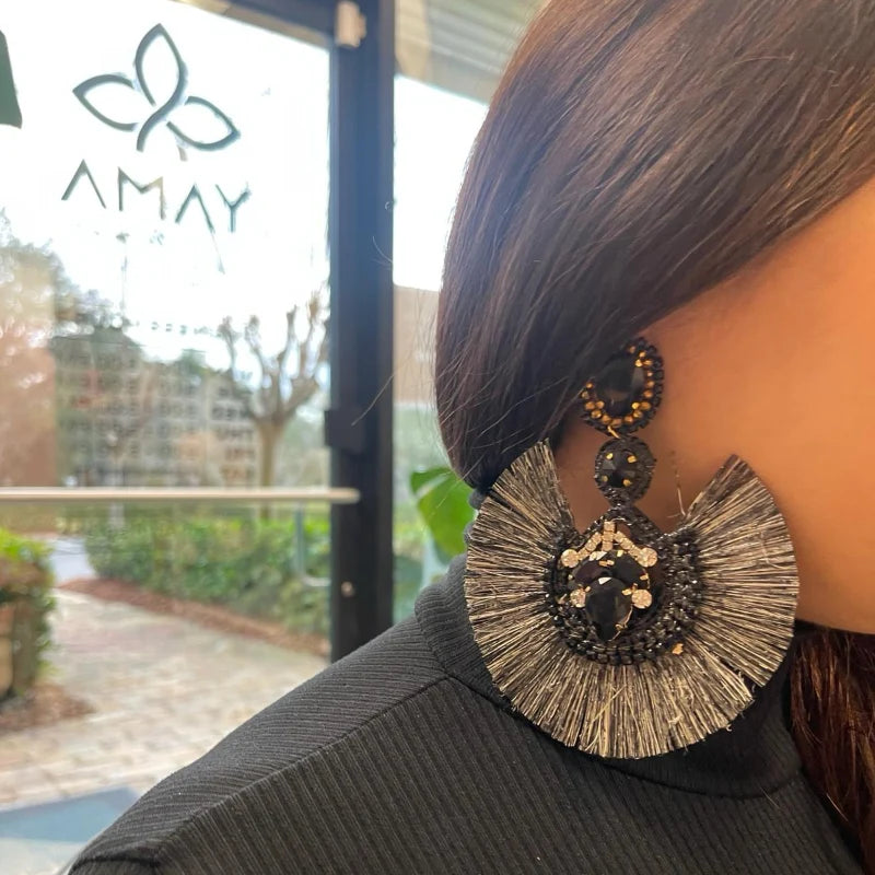 woman wearing statement black earrings