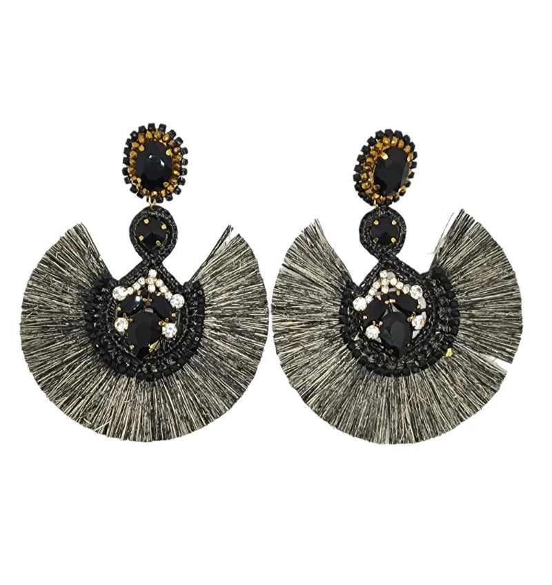 Handcrafted by Colombian Artisans, these earrings feature black-painted Totumo crafted into crescent moon shapes, adorned with delicate white, black, and gold gemstones.