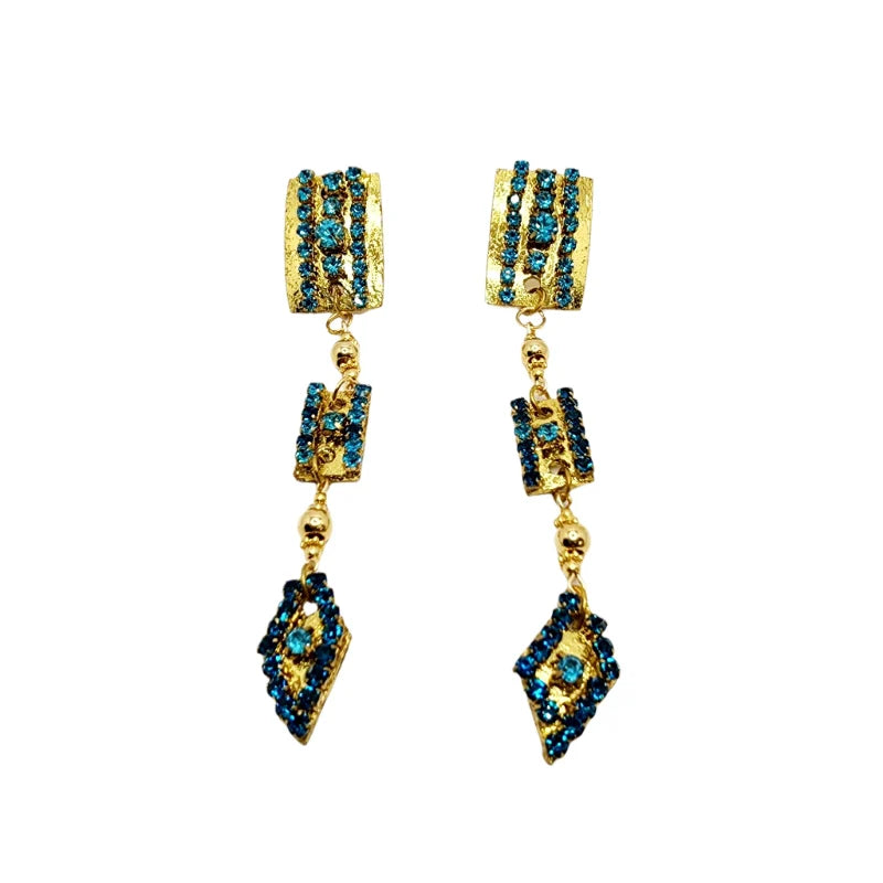 These elegant blue and gold earrings feature a layered design with oval, smaller middle, and diamond-shaped sections, all adorned with embedded blue gemstones and connected by delicate golden chains