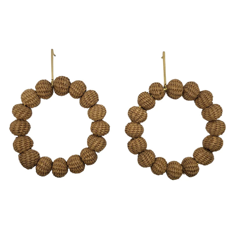 These large bead earrings dangle elegantly in a circular shape, beautifully combined with fine jewelry accents. Handmade with natural Banana Tree Fibers, they are stunningly decorated with carefully selected beads.