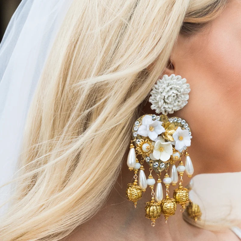 Close-up of a woman wearing bridal earrings.