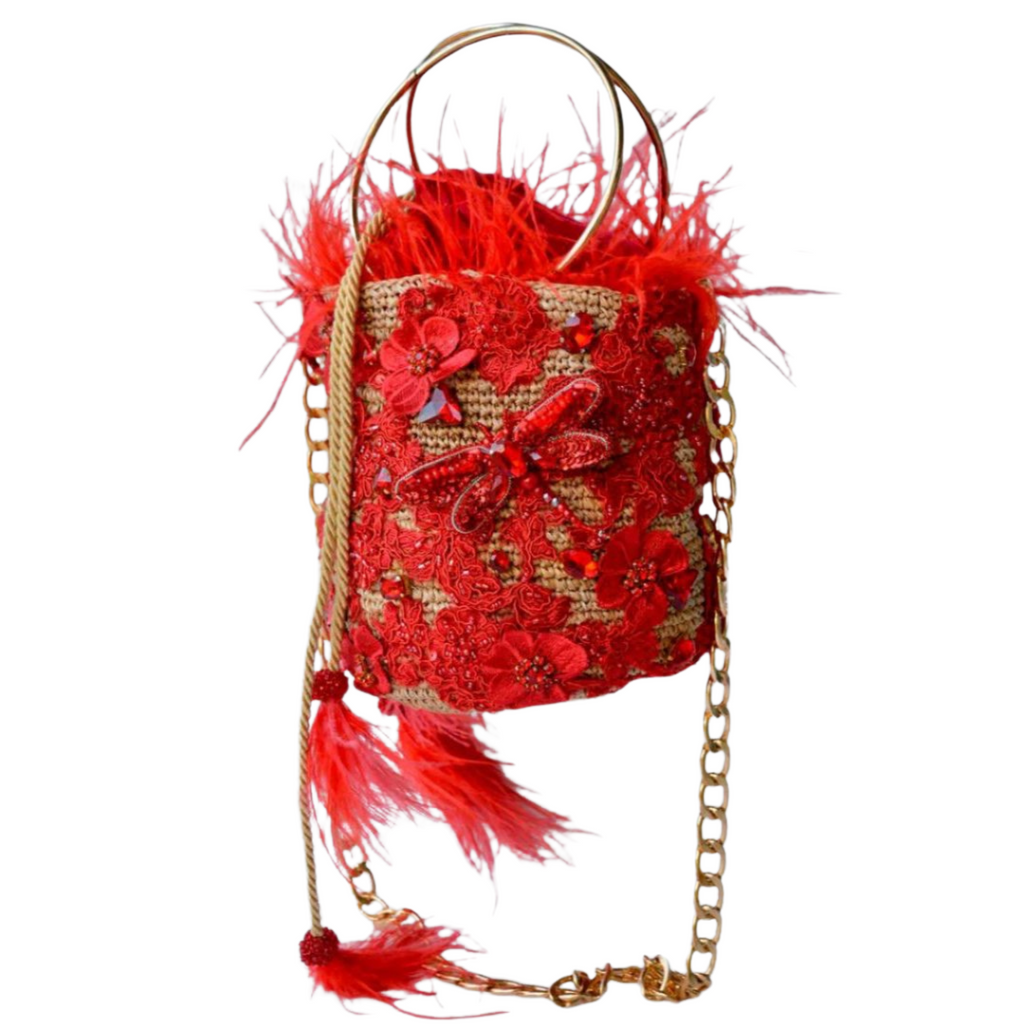 Handcrafted red feather minaudière bag adorned with intricate lace, crystals, and gold chain strap.