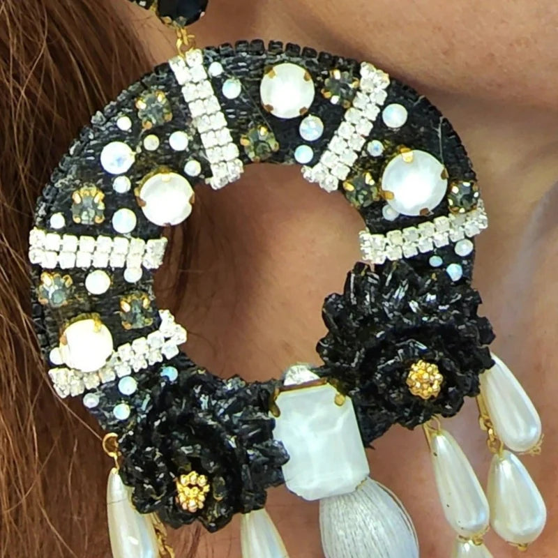 woman wearing statemet black earrings