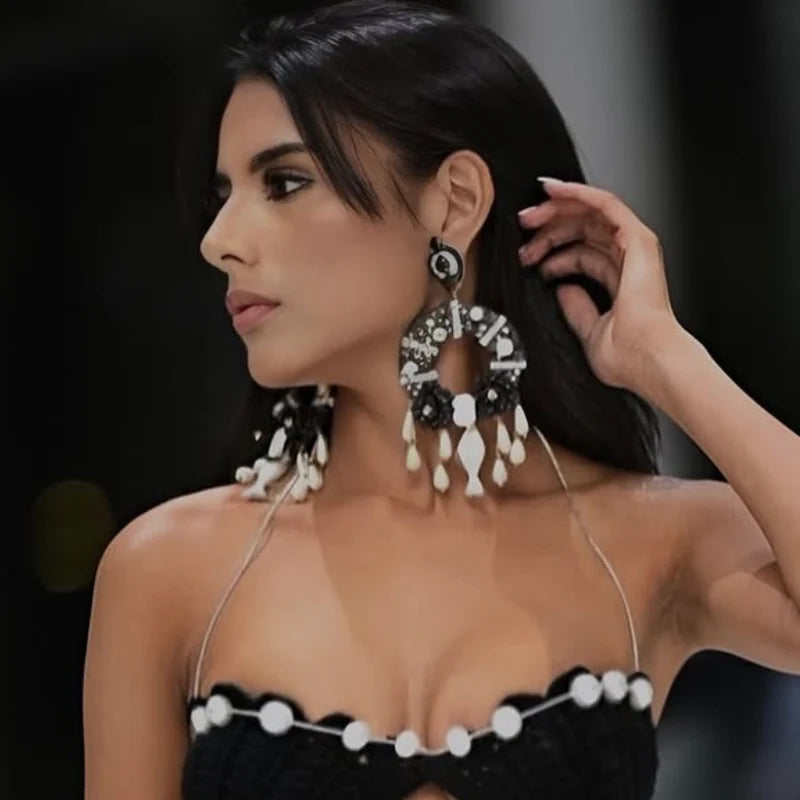 woman wearing statemet black earrings