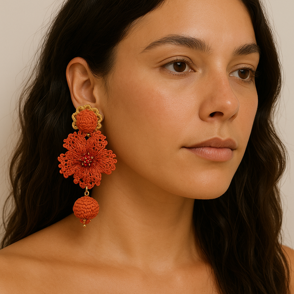 Model wearing Flame Petal Earrings with orange thread petals, red beads, and woven charm — artisan handcrafted statement jewelry