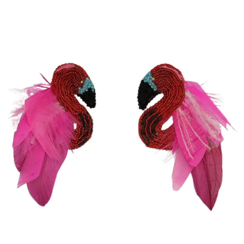 These masterpiece earrings blend the beauty of sun, feathers, flowers, and birds, reflecting God's wonderful creation. The birds are handcrafted from wood and painted by talented Colombian artisans, with each detail imbued with patience, passion, and love.