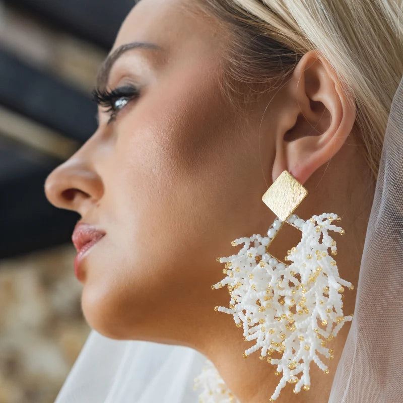 woman wearing a bride earrings 