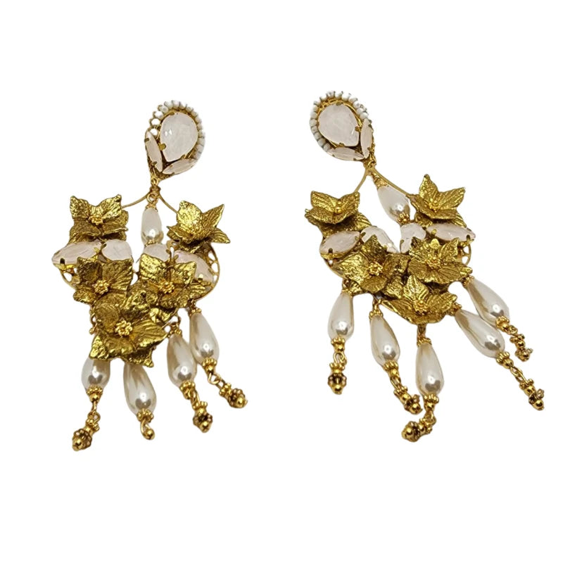 Pair of elegant gold floral earrings with pearl drops and translucent crystal accents, handcrafted with intricate detail.