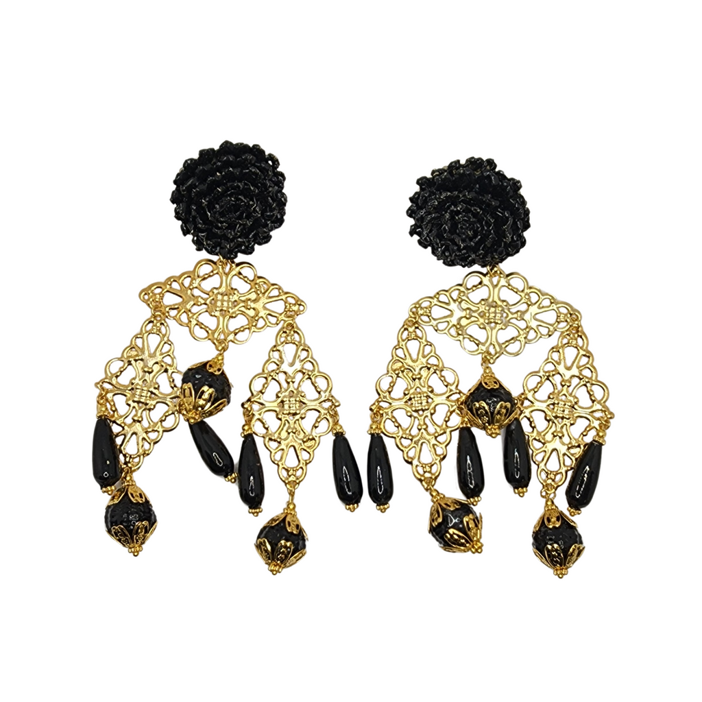 Black and gold earrings with a woven floral stud, ornate gold filigree, and bold black dangling beads.