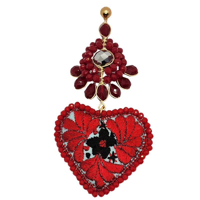 Experience the rich heritage of Mexico with our red earrings adorned with flowers and hearts, handcrafted by skilled local artisans. Each pair blends tradition and creativity, showcasing the beauty of Mexican craftsmanship.