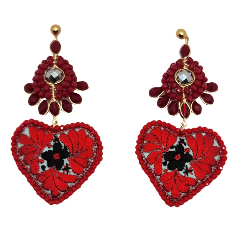 Experience the rich heritage of Mexico with our red earrings adorned with flowers and hearts, handcrafted by skilled local artisans. Each pair blends tradition and creativity, showcasing the beauty of Mexican craftsmanship.