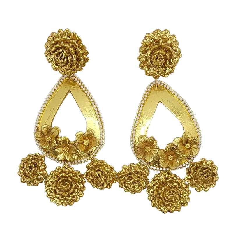Discover the charm of exquisite Colombian handcrafted earrings, adorned with two types of golden painted flowers and delicate white gemstone leaf accents.