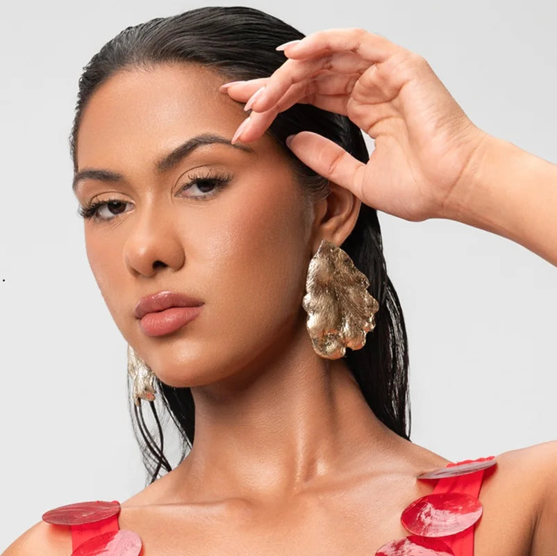 Define your presence with a piece that radiates character, sophistication, and modernity. The Avant-Garde Gold Earrings are sculpted with an organic silhouette and a rough, irregular texture that catches the light from every angle, making them the ultimate style statement for the contemporary woman.