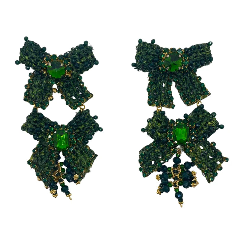 These stunning earrings feature two large, beautiful bows, delicately decorated with Murano stones, symbolizing the joy of gifting. Handcrafted with banana tree fibers, these earrings are a true representation of craftsmanship and elegance.