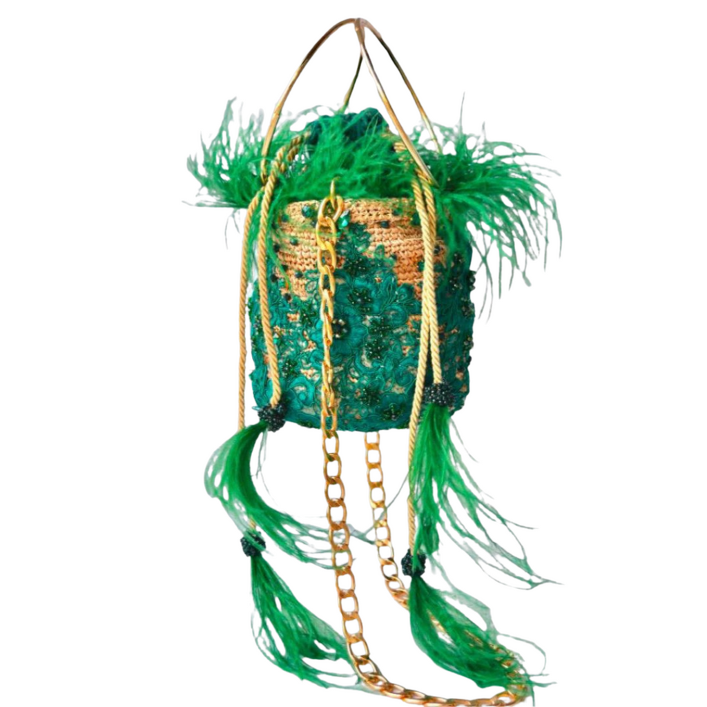 Handcrafted green feather embellished bucket bag with intricate lace embroidery, gemstone accents, and gold chain and rope straps.