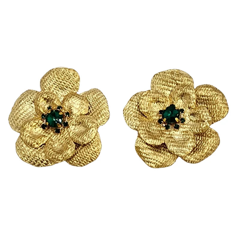woman wearing a golden flawer earrings