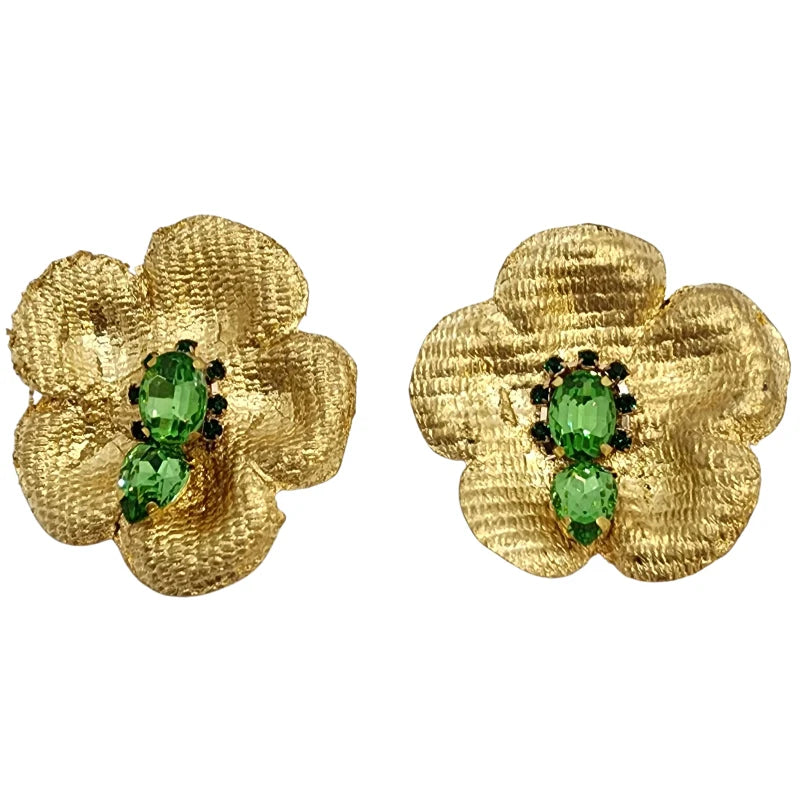 woman wearing a golden flawer earrings