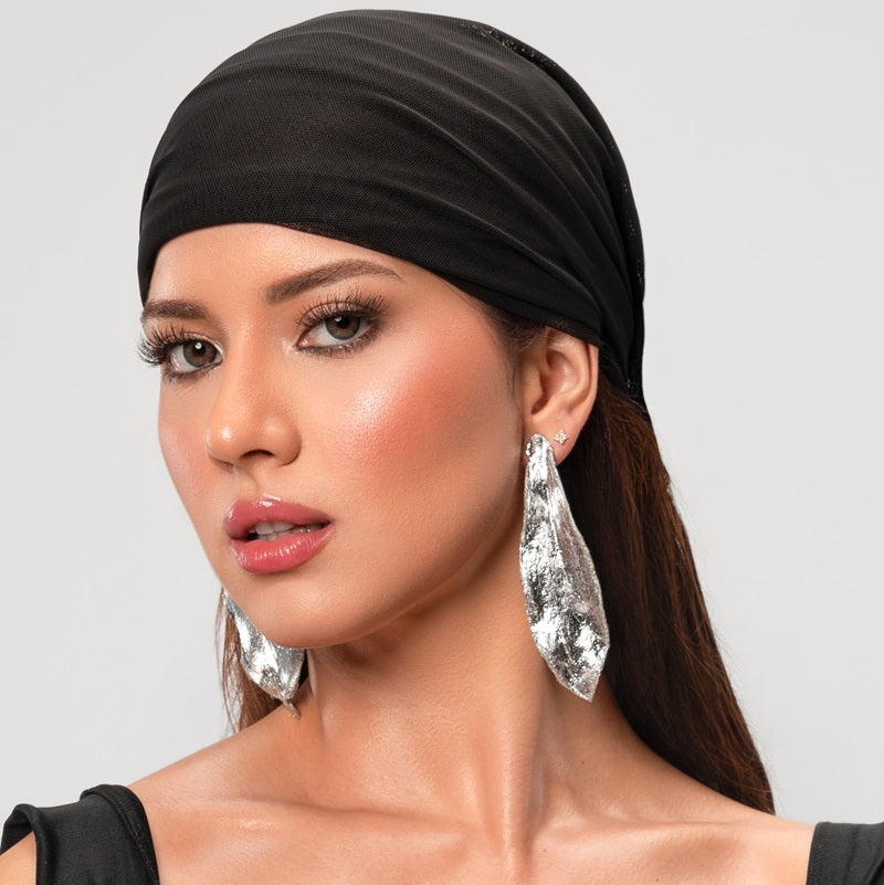 woman wearing a stament earrings