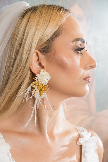 Bridal earrings with white beading, gold accents, and delicate feather details.