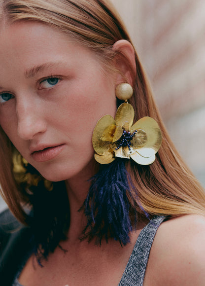 Model wearing statement earrings 