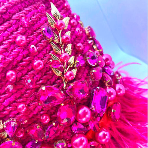Close-up of gold leaf embroidery and pink bead accents on fuchsia handcrafted bucket bag.