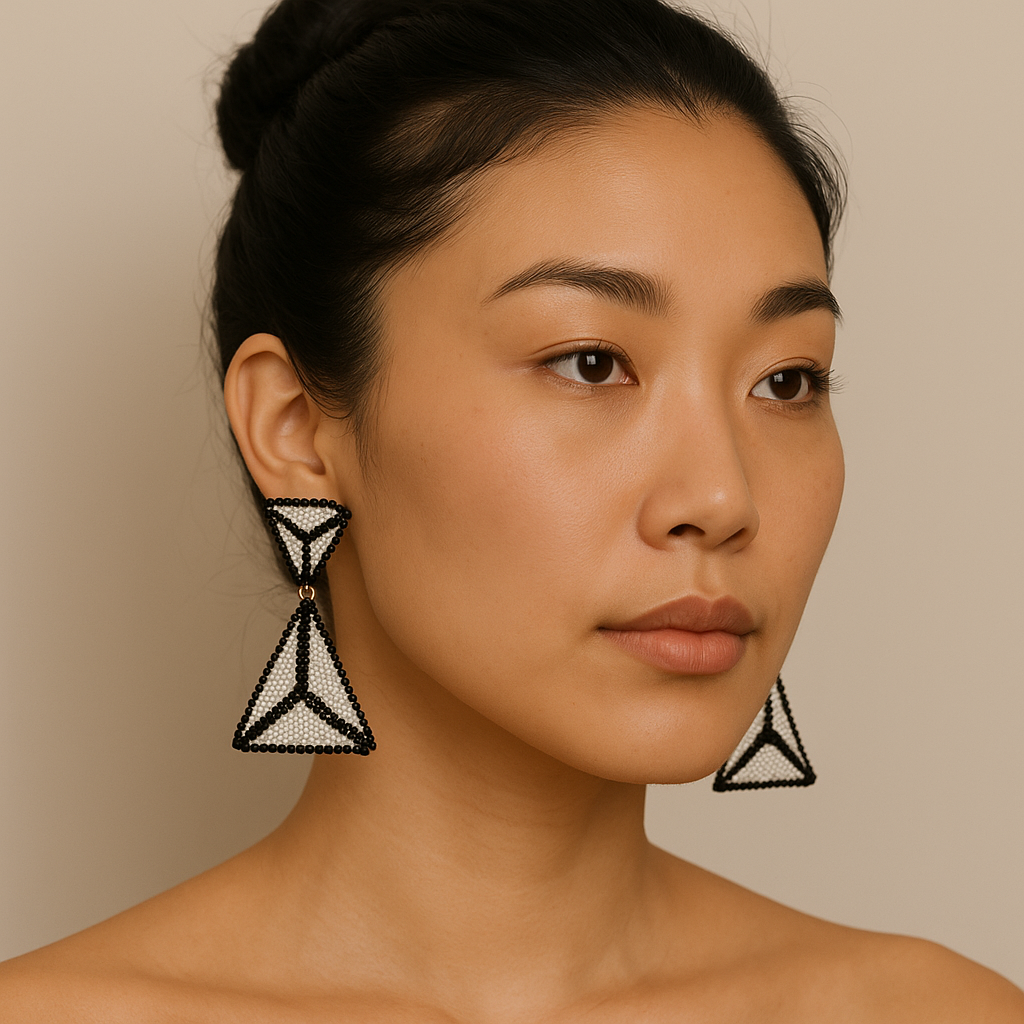 Model wearing Miyuki Doble Triangle Earrings with white and black glass bead pattern and triangular handcrafted design