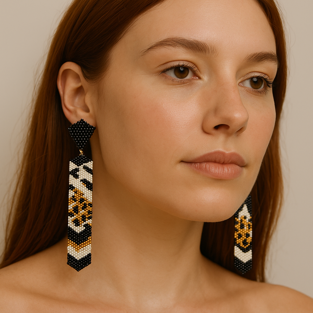 Model wearing Miyuki Tie Earrings with black and white glass beads and golden details — modern handcrafted statement earrings