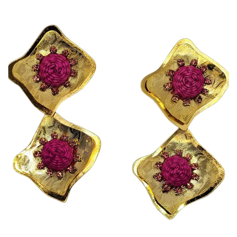 The Sun Pearls Earrings beautifully combine natural fibers and dazzling Murano stones to create a radiant sun-shaped design. Adorned with dangling Murano beads and fine jewelry accents, these earrings shine with elegance and charm.
