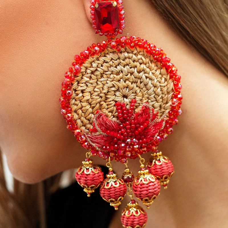 These majestic earrings feature a whole moon shape, highlighted by a shiny orange Murano stone at the center. 